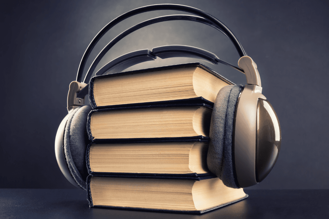 Headphones wrapped around a stack of books