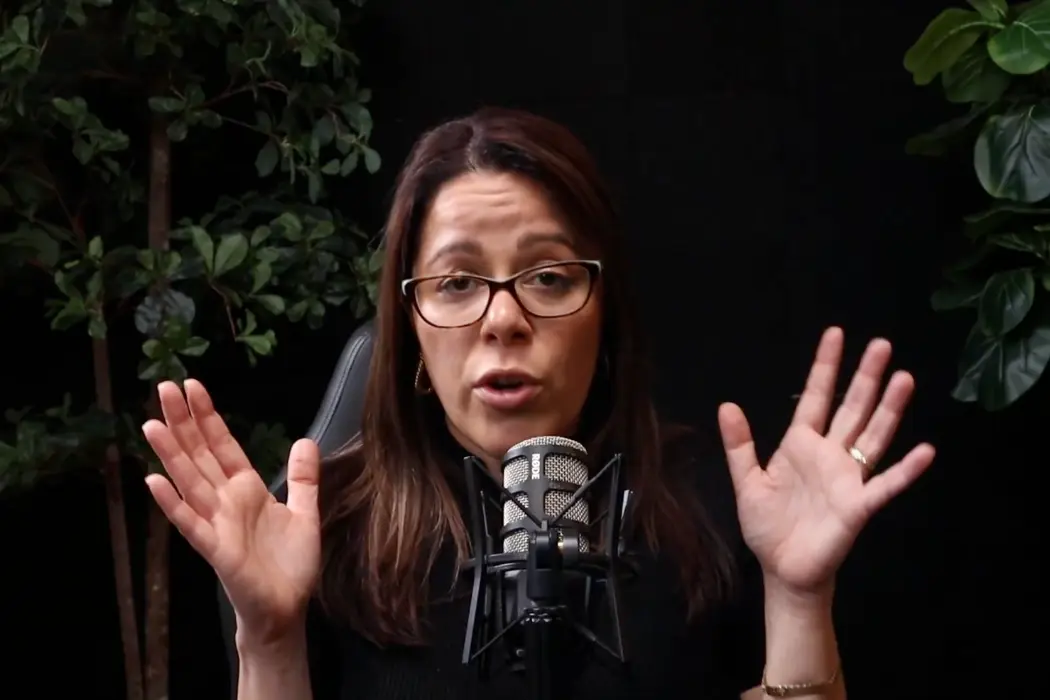 Presenter speaking into a broadcast mic during a live stream